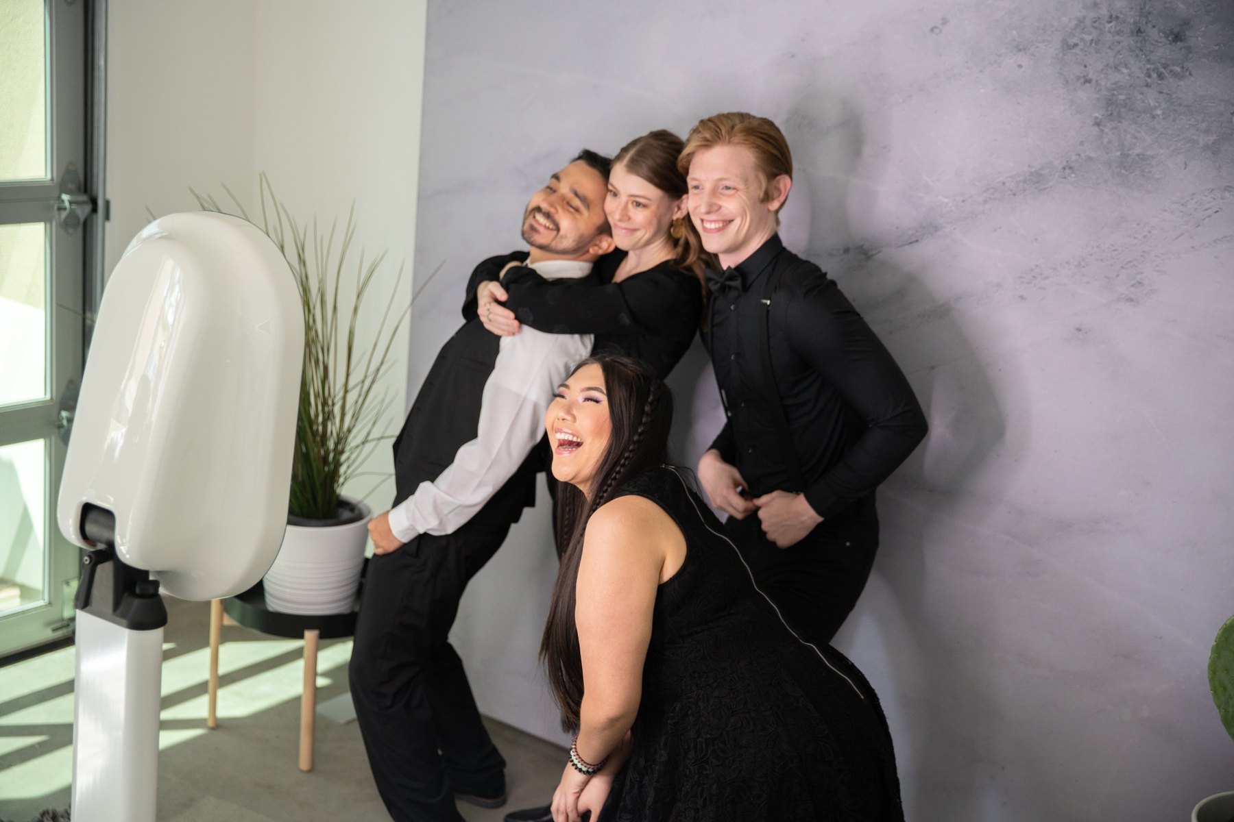 Formal event guests posing at a photo booth