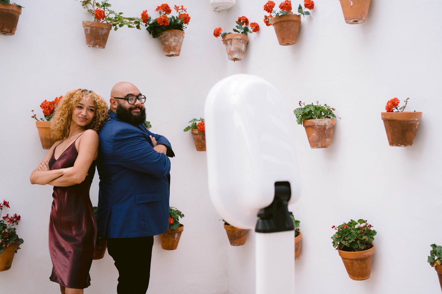 Two guests posing beside the booth at a garden event